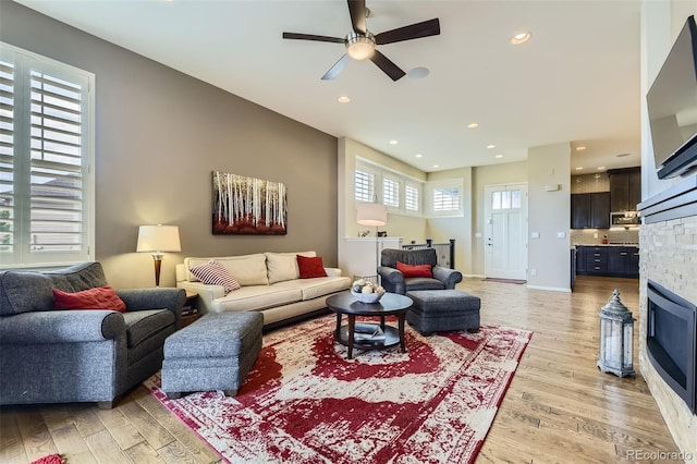 3477 New Haven Cir, Castle Rock, CO 80109 - living area with light wood finished floors, a ceiling fan, recessed lighting, and a stone fireplace