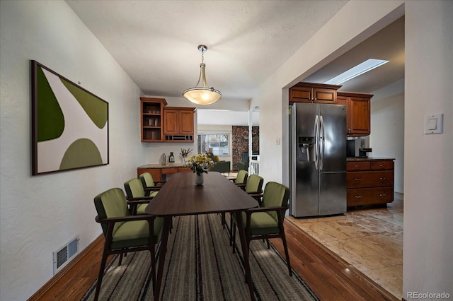 dining room featuring a skylight