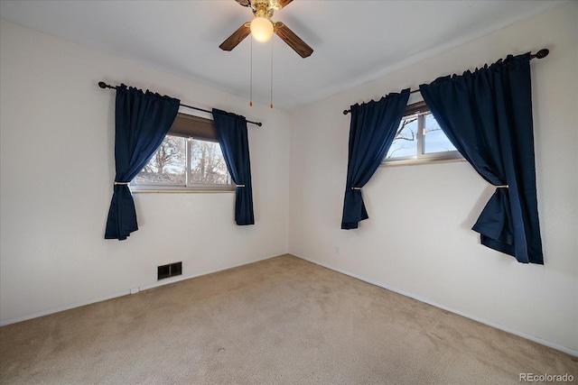 carpeted empty room featuring ceiling fan