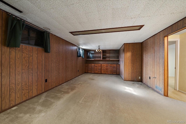 interior space with light colored carpet and wooden walls