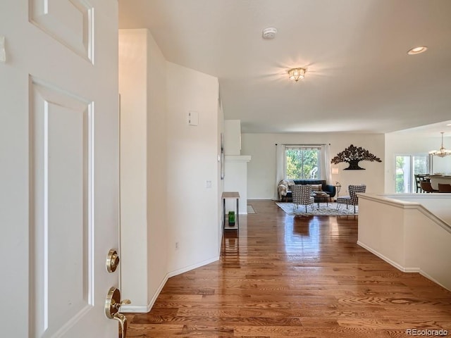 7746 S Valdai Ct, Aurora, CO 80016 - corridor featuring wood finished floors, a chandelier, and recessed lighting