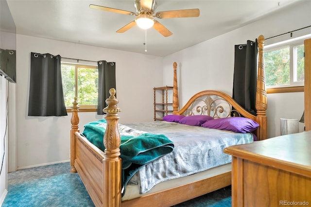 bedroom with baseboards, multiple windows, ceiling fan, and carpet flooring