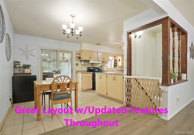 dining room with baseboards and ceiling fan with notable chandelier