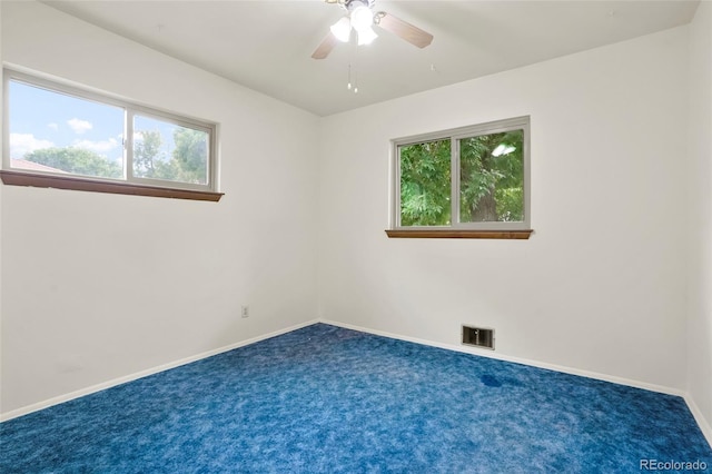 spare room with baseboards, visible vents, ceiling fan, and carpet flooring