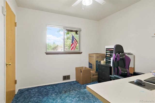 office area with baseboards, visible vents, ceiling fan, and carpet flooring