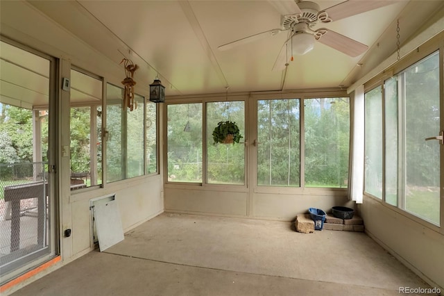 unfurnished sunroom with ceiling fan and a wealth of natural light