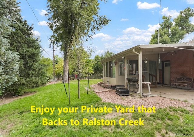 view of yard with a patio and a sunroom