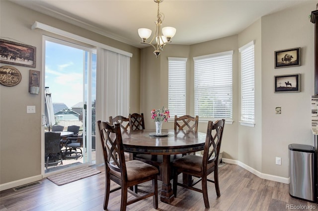 24351 E Alamo Dr, Aurora, CO 80016 - dining space with wood finished floors, a chandelier, and baseboards