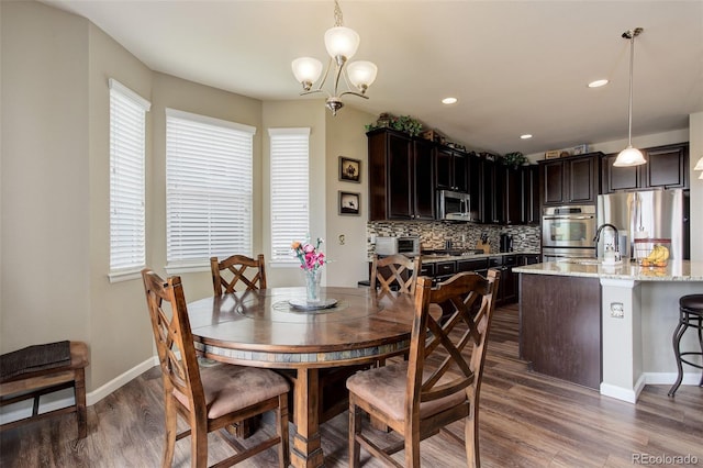 24351 E Alamo Dr, Aurora, CO 80016 - dining area featuring dark wood-type flooring, a chandelier, baseboards, and recessed lighting