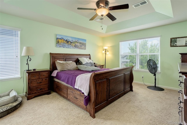 24351 E Alamo Dr, Aurora, CO 80016 - bedroom featuring light colored carpet, a tray ceiling, baseboards, and ceiling fan