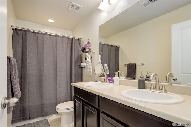 24351 E Alamo Dr, Aurora, CO 80016 - bathroom featuring toilet, double vanity, and recessed lighting