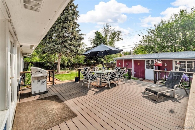 1648 S Locust St, Denver, CO 80224 - wooden terrace featuring a grill, outdoor dining space, and a fenced backyard