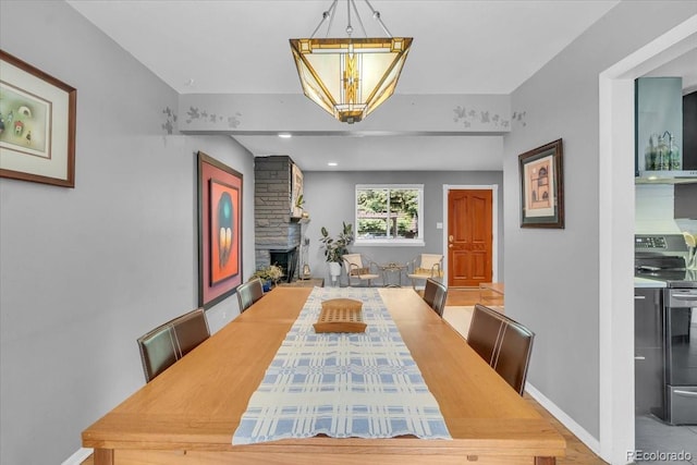 1648 S Locust St, Denver, CO 80224 - dining space featuring a chandelier and a fireplace