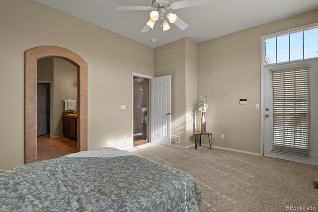 bedroom with ensuite bathroom, light carpet, access to exterior, and ceiling fan