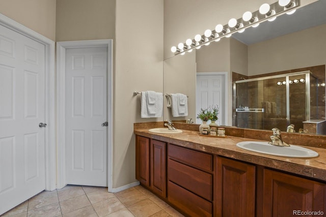 bathroom with vanity, a shower with shower door, and tile patterned flooring