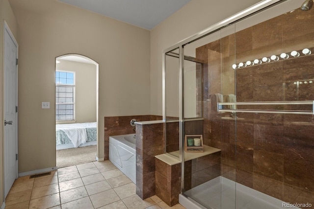 bathroom with tile patterned flooring and independent shower and bath