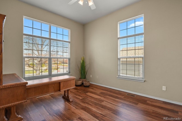 home office featuring ceiling fan and dark hardwood / wood-style flooring