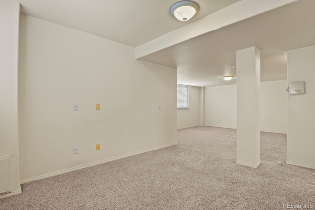 basement featuring light colored carpet