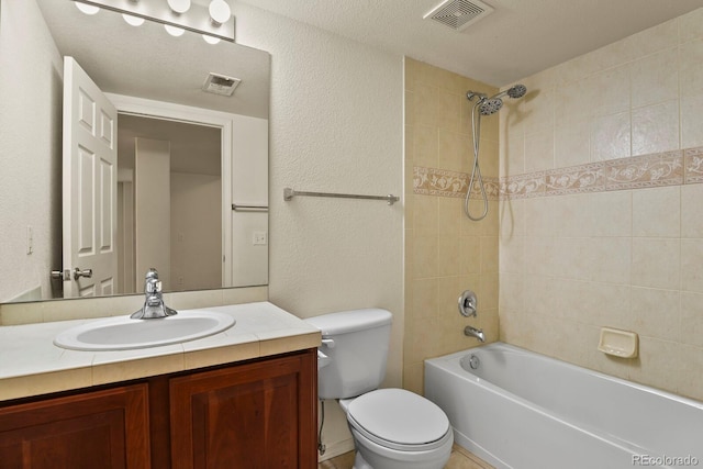 full bathroom with vanity, toilet, and tiled shower / bath combo