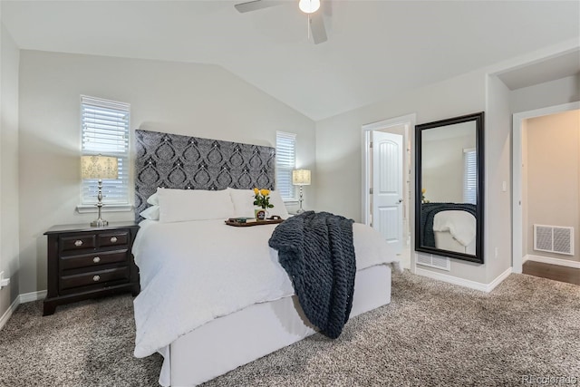 bedroom featuring dark colored carpet, lofted ceiling, and ceiling fan