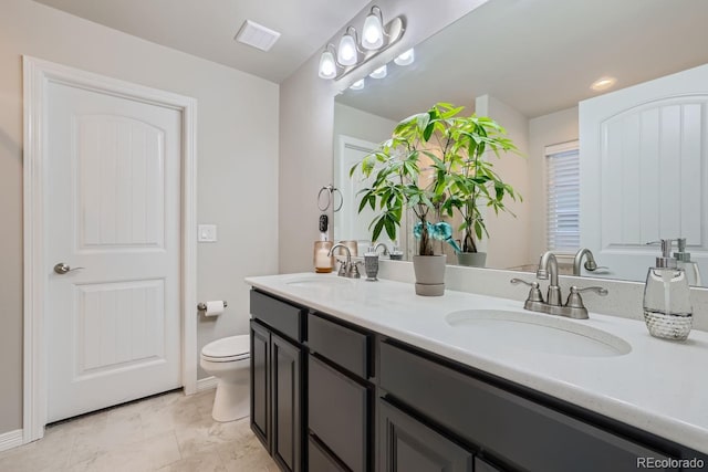 bathroom with vanity and toilet