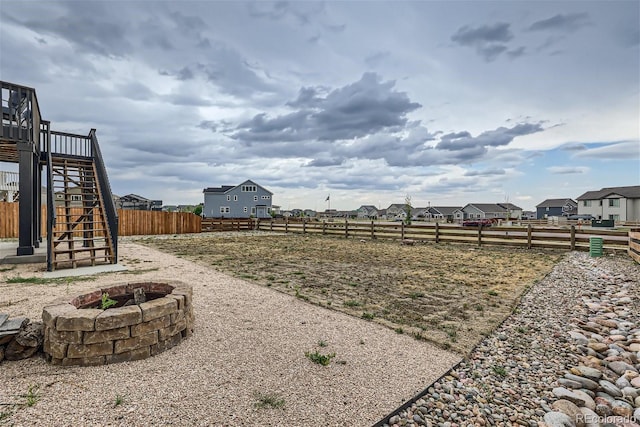 view of yard with a fire pit