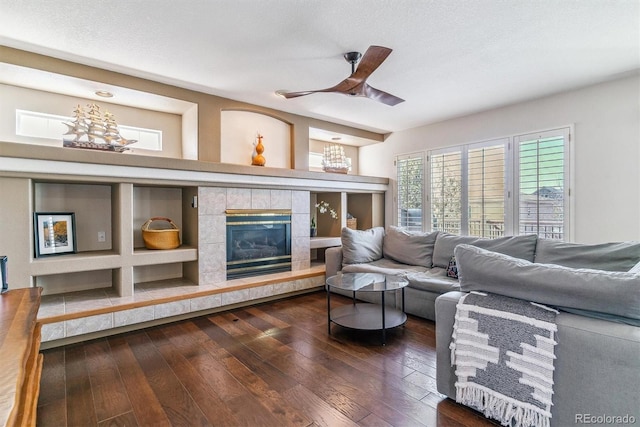 9109 Ironwood Way, Highlands Ranch, CO 80129 - living area featuring ceiling fan, a tile fireplace, and dark wood finished floors
