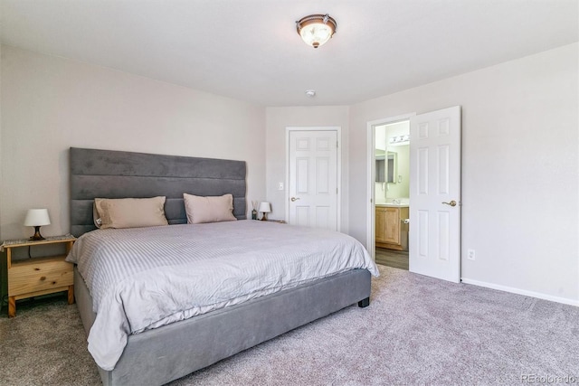 9109 Ironwood Way, Highlands Ranch, CO 80129 - bedroom with baseboards, ensuite bath, and carpet floors