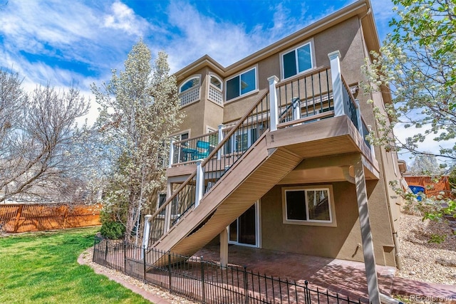 9109 Ironwood Way, Highlands Ranch, CO 80129 - back of house featuring stucco siding, stairway, a balcony, and a patio