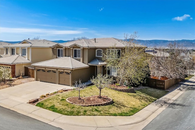 9109 Ironwood Way, Highlands Ranch, CO 80129 - traditional home with a garage, driveway, a mountain view, a tile roof, and stucco siding