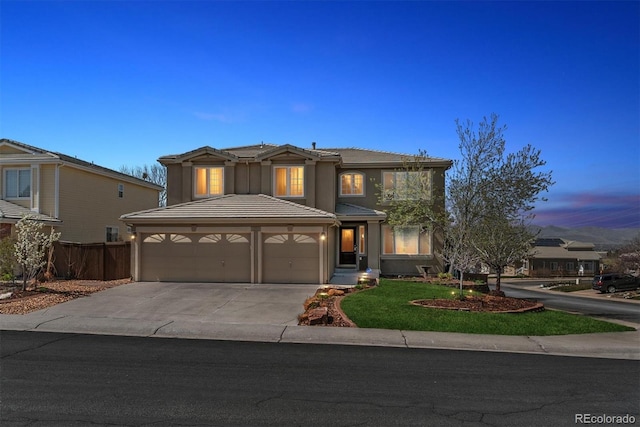 9109 Ironwood Way, Highlands Ranch, CO 80129 - traditional-style house featuring a garage, concrete driveway, and stucco siding