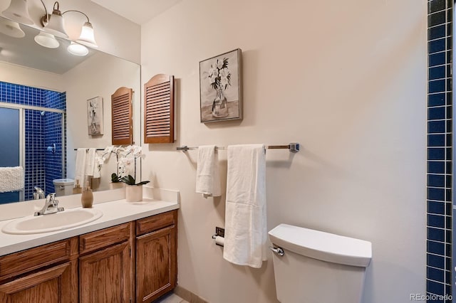 bathroom with vanity, toilet, and a stall shower
