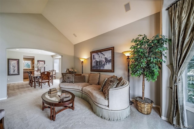 19676 E Pinewood Dr, Aurora, CO 80016 - living room featuring arched walkways, carpet floors, and high vaulted ceiling