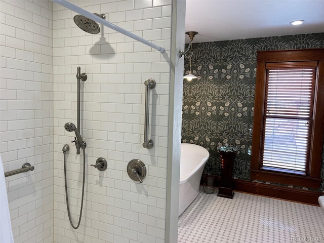 full bath featuring a freestanding bath, a tile shower, and wallpapered walls