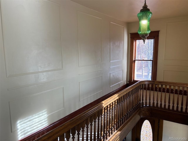 hallway featuring a decorative wall
