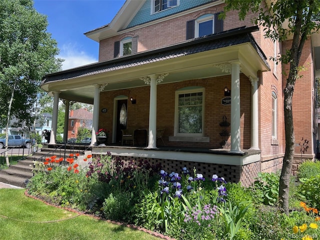 405 2nd Ave, Monte Vista, CO 81144 - property entrance featuring a porch and brick siding