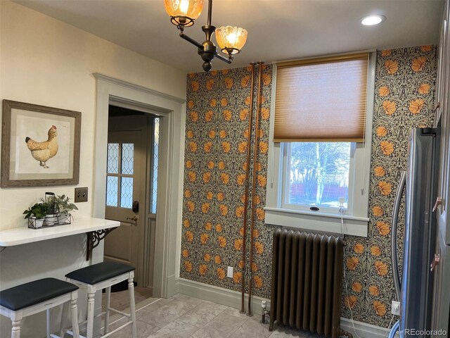 405 2nd Ave, Monte Vista, CO 81144 - dining space with radiator, baseboards, plenty of natural light, and recessed lighting