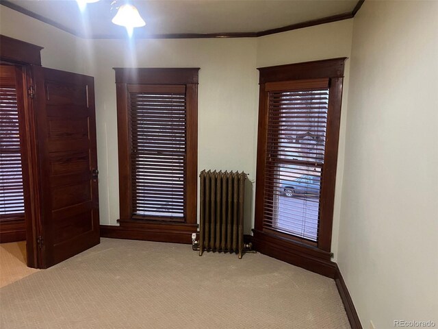 405 2nd Ave, Monte Vista, CO 81144 - bedroom featuring radiator, light carpet, crown molding, and baseboards