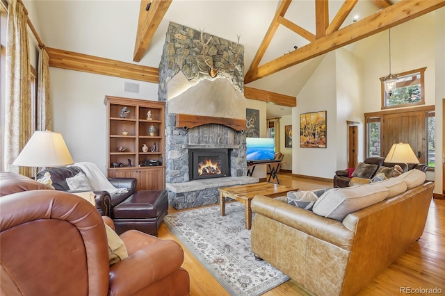 44 Canyon Ct, Eagle, CO 81631 - living area with high vaulted ceiling, a fireplace, beam ceiling, wood finished floors, and baseboards