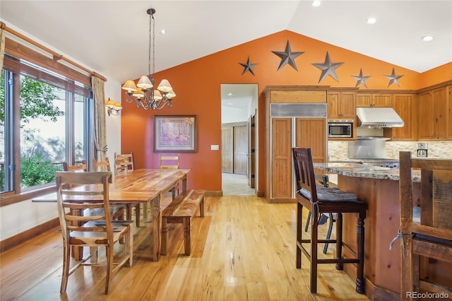 44 Canyon Ct, Eagle, CO 81631 - dining space featuring vaulted ceiling, light wood finished floors, plenty of natural light, a chandelier, and recessed lighting