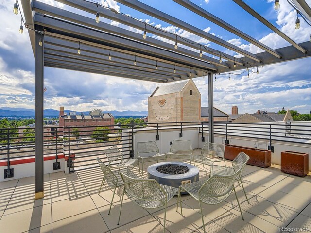 2374 S University Blvd Unit 205, Denver, CO 80210 - view of patio with a pergola, an outdoor fire pit, and a mountain view