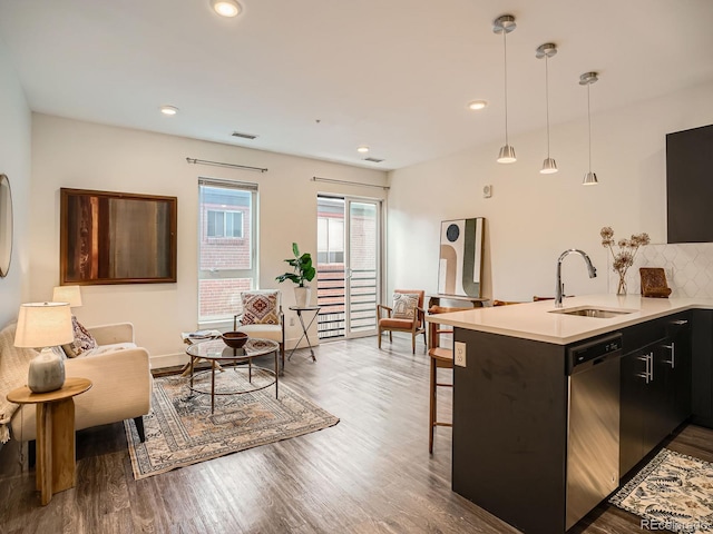 2374 S University Blvd Unit 205, Denver, CO 80210 - kitchen featuring dishwasher, a kitchen breakfast bar, decorative light fixtures, light countertops, and wood finished floors
