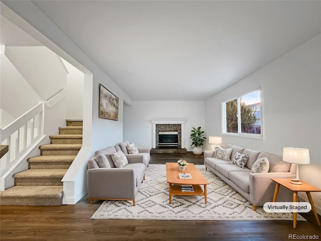 living room with hardwood / wood-style flooring and a fireplace