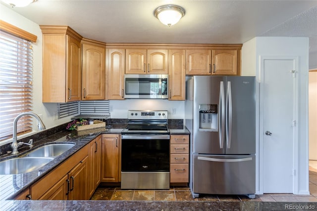 19630 E Purdue Pl, Aurora, CO 80013 - kitchen featuring appliances with stainless steel finishes, dark stone countertops, and dark stone finish flooring
