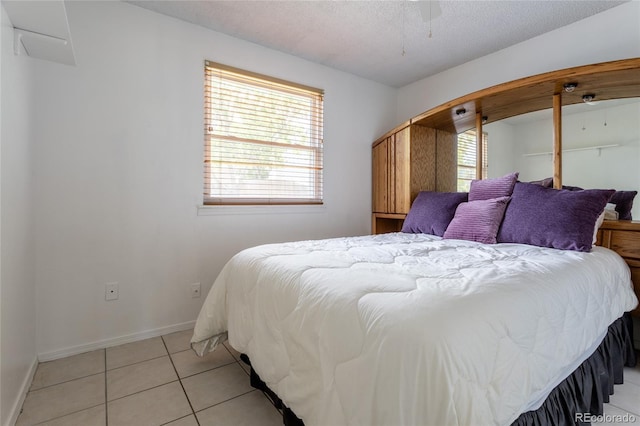 19630 E Purdue Pl, Aurora, CO 80013 - bedroom featuring multiple windows, light tile patterned flooring, and a textured ceiling