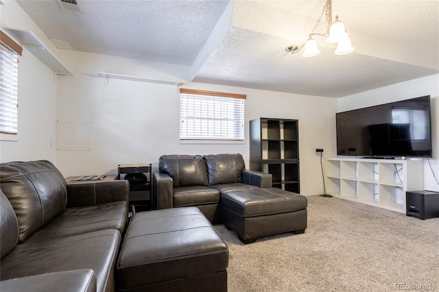 19630 E Purdue Pl, Aurora, CO 80013 - living area featuring a textured ceiling, carpet, and a chandelier