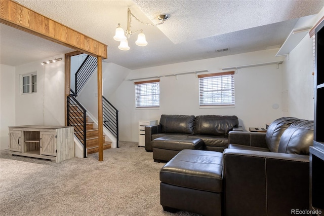 19630 E Purdue Pl, Aurora, CO 80013 - carpeted living area featuring stairway, a textured ceiling, and a chandelier