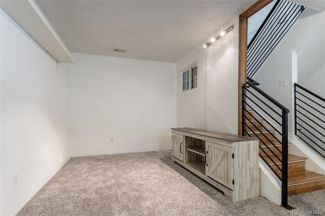 19630 E Purdue Pl, Aurora, CO 80013 - basement with carpet floors, stairs, and a textured ceiling
