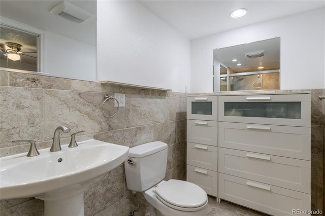 19630 E Purdue Pl, Aurora, CO 80013 - bathroom featuring tile walls, an enclosed shower, ceiling fan, and a wainscoted wall