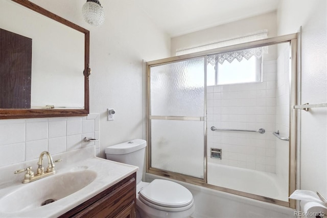 5935 Blanca Ct, Golden, CO 80403 - bathroom with vanity, combined bath / shower with glass door, and decorative backsplash